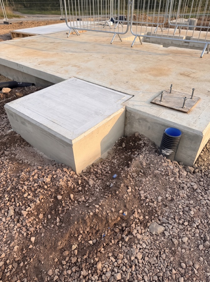 The same concrete landing pad with the clutter removed, in warm evening light